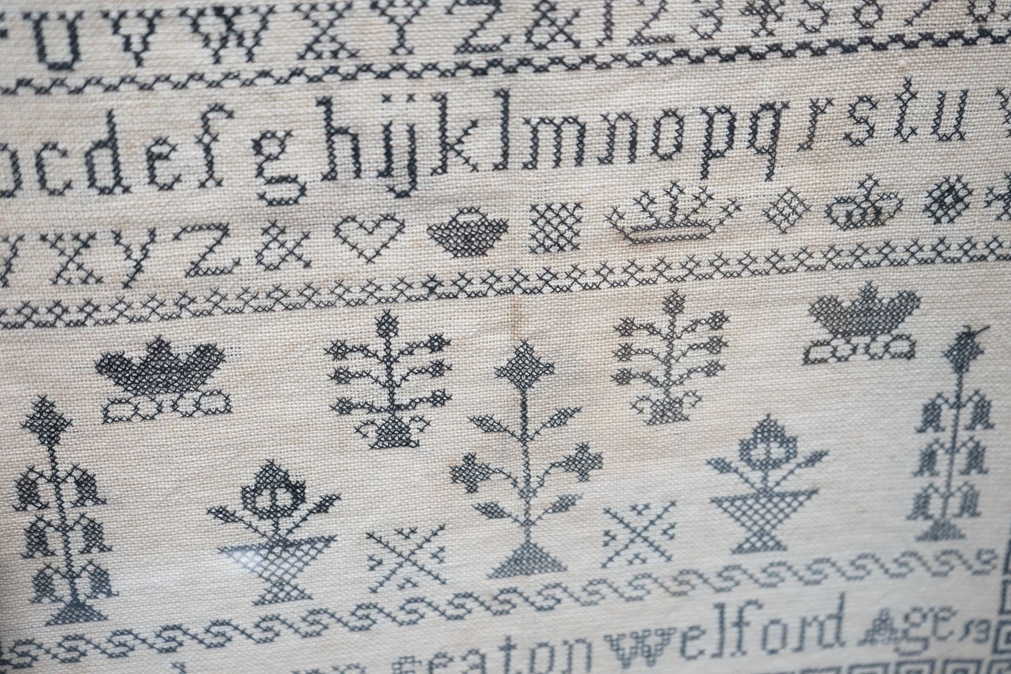 A framed Victorian alphabet sampler by Sarah Ann Seaton Welford, aged 13, 32x33cm